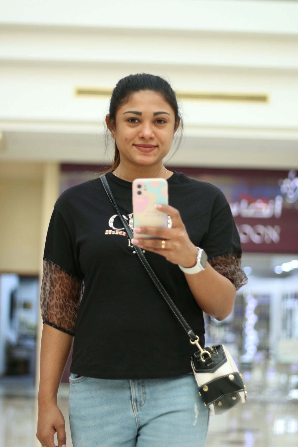 a woman taking a picture of herself with her cell phone