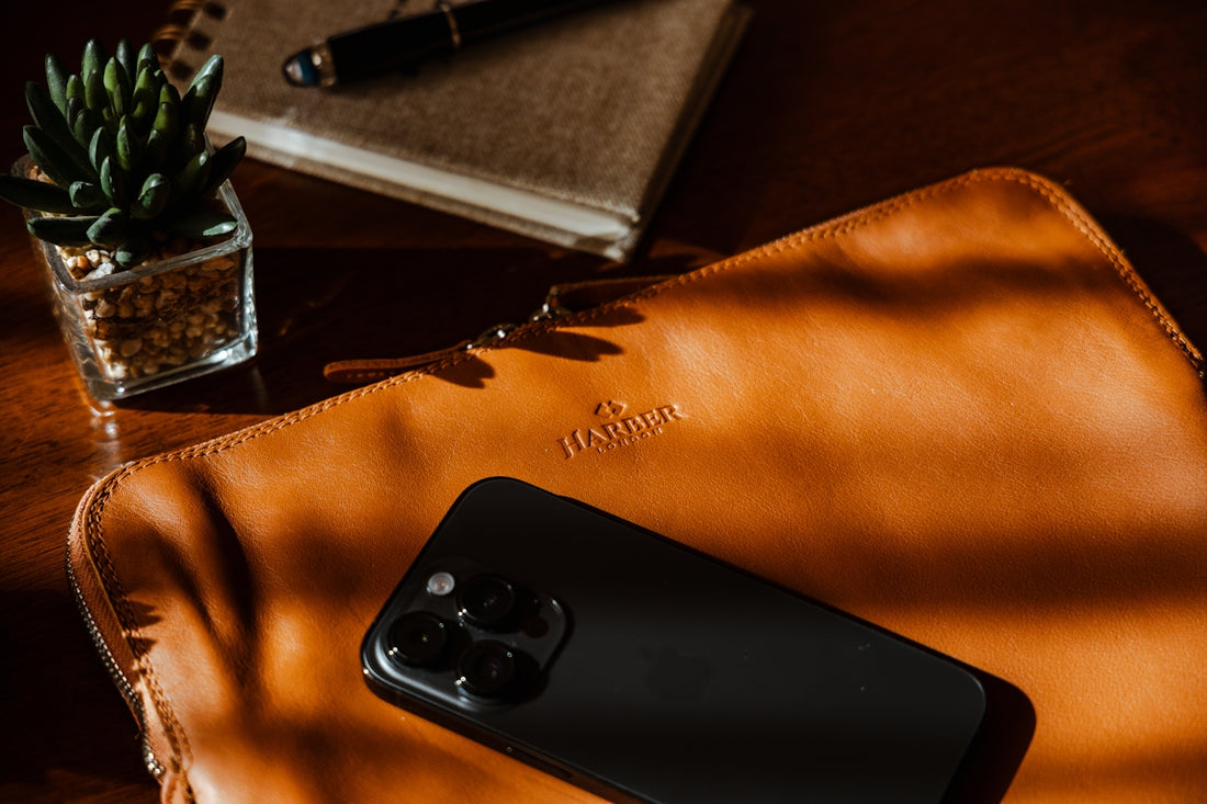 a cell phone sitting on top of a brown bag