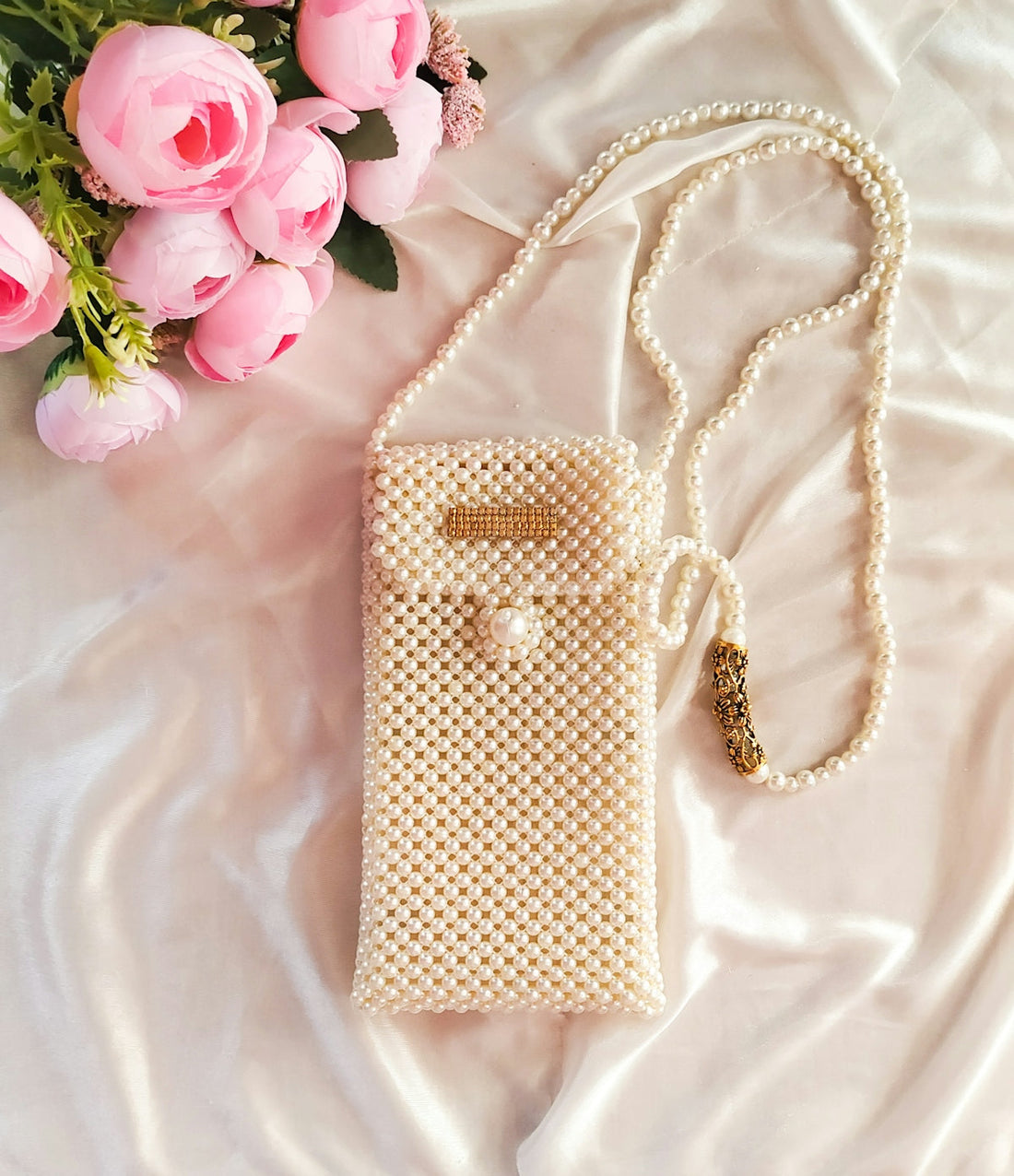 A white cell phone case sitting on top of a bed