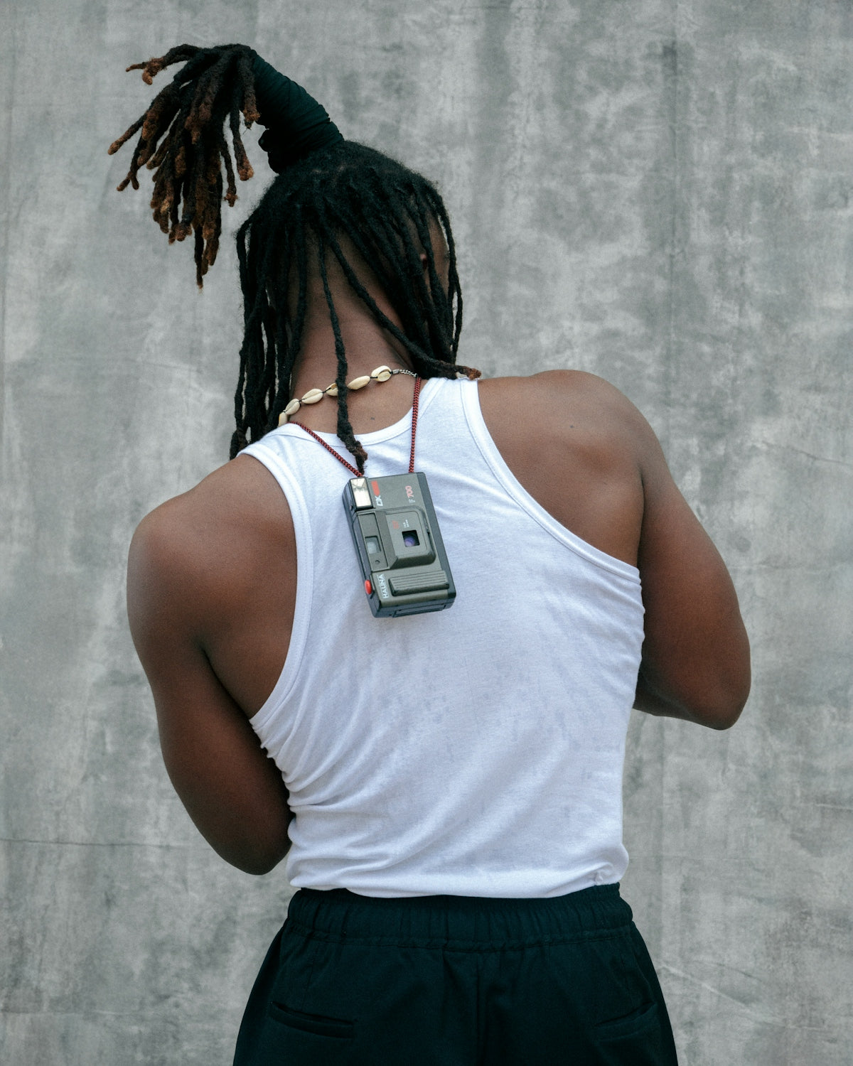A man with dreadlocks and a cell phone
