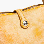 MUGRS women's crossbody phone bag – leather tuck-lock closure with single polished stud, detail
