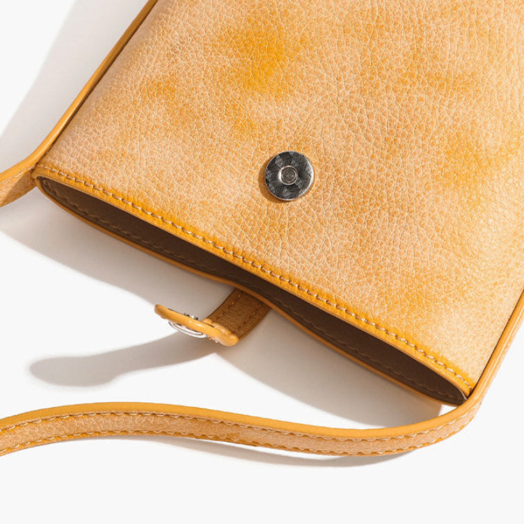 MUGRS women's mini leather bag – tuck-lock front closure detail, no zipper, one-hand access