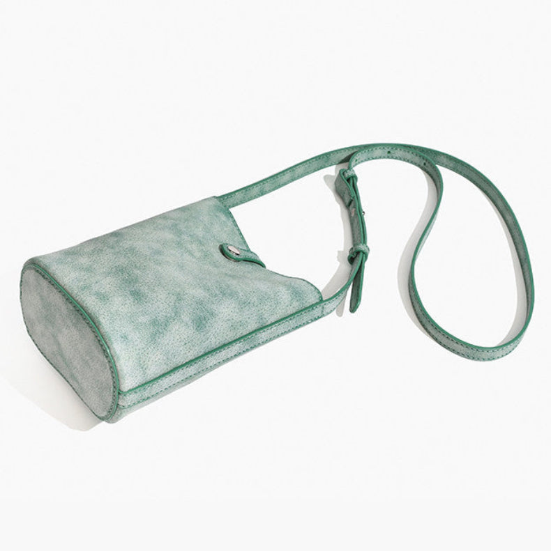 MUGRS women's mini crossbody bag in Green – front and angle views, muted green leather