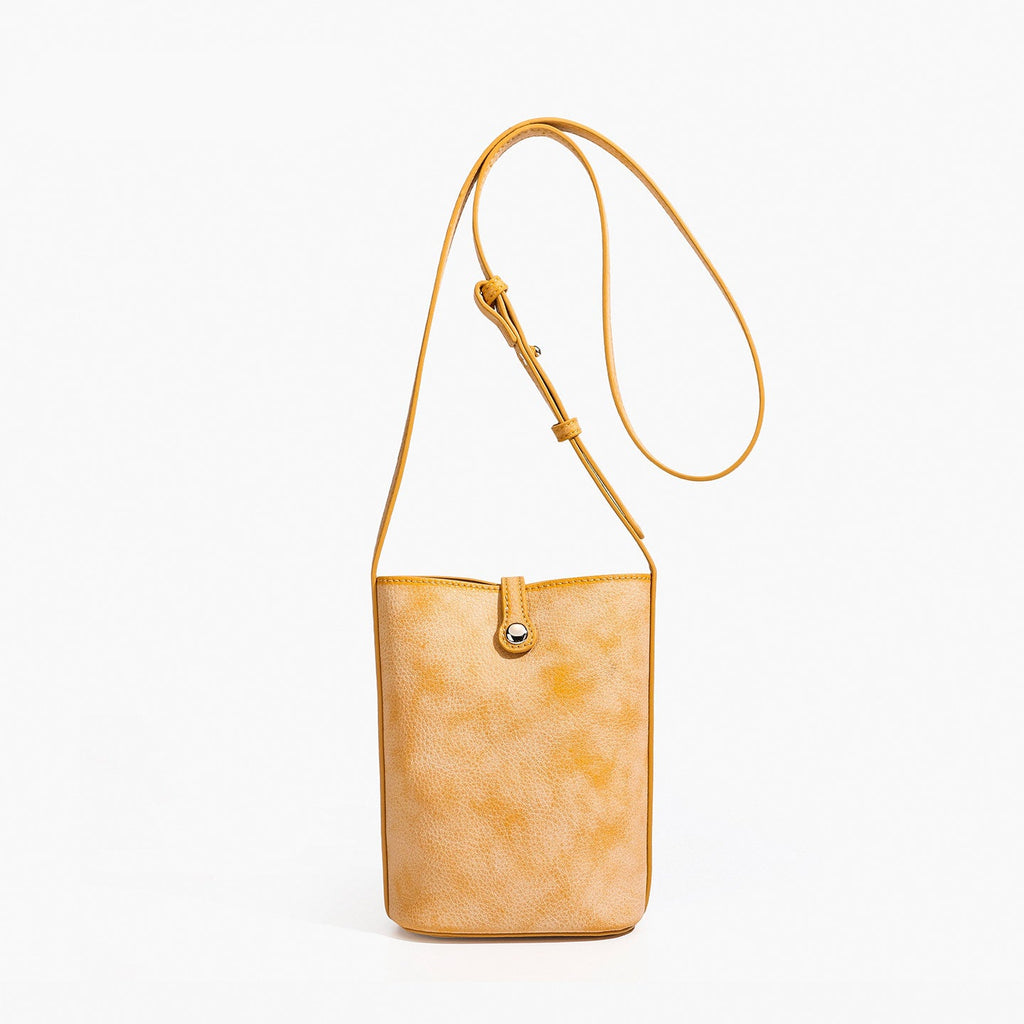 MUGRS women's leather crossbody bag in Orange – front view, lightweight everyday carry