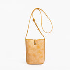 MUGRS women's leather crossbody bag in Orange – front view, lightweight everyday carry