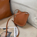 MUGRS women's phone bag in Muddy – shoulder strap worn, simple, hands-free
