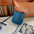 MUGRS women's phone bag in Blue – crossbody worn by model, soft leather, hands-free