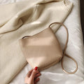 MUGRS women's crossbody bag in Apricot – bottom with base detail, compact, hands-free