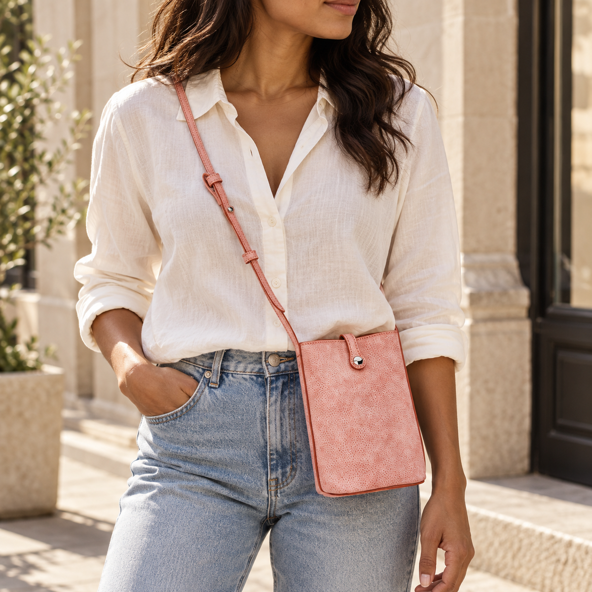 MUGRS women's crossbody phone bag in Pink – worn over a linen shirt, hands-free everyday carry