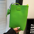 MUGRS women's phone bag in Grass Green – folded compact view, compact, hands-free